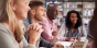 diverse group of adult students participating in a class